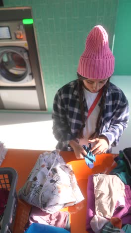 girl doing laundry at a laundromat