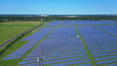5g telecommunication tower in a huge solar panel plant in germany, capturing the convergence of technology and sustainability. beautiful aerial view flight panorama overview drone