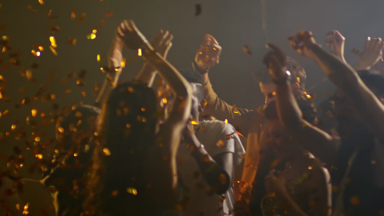 Joyful Crowd Dancing in Confetti Shower
