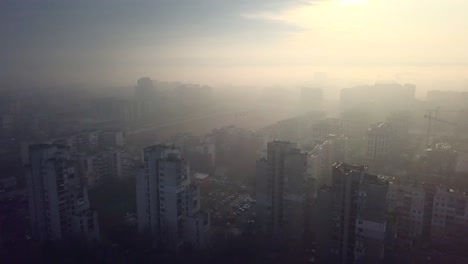 Flying-over-a-concrete-living-apartment-area-in-east-Europa-with-many-birds-flying-around-the-drone