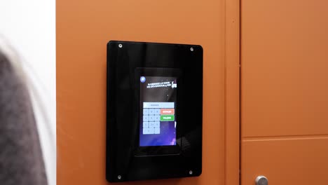 slow motion shot of a man inputting a digital password into a keypad opening a door