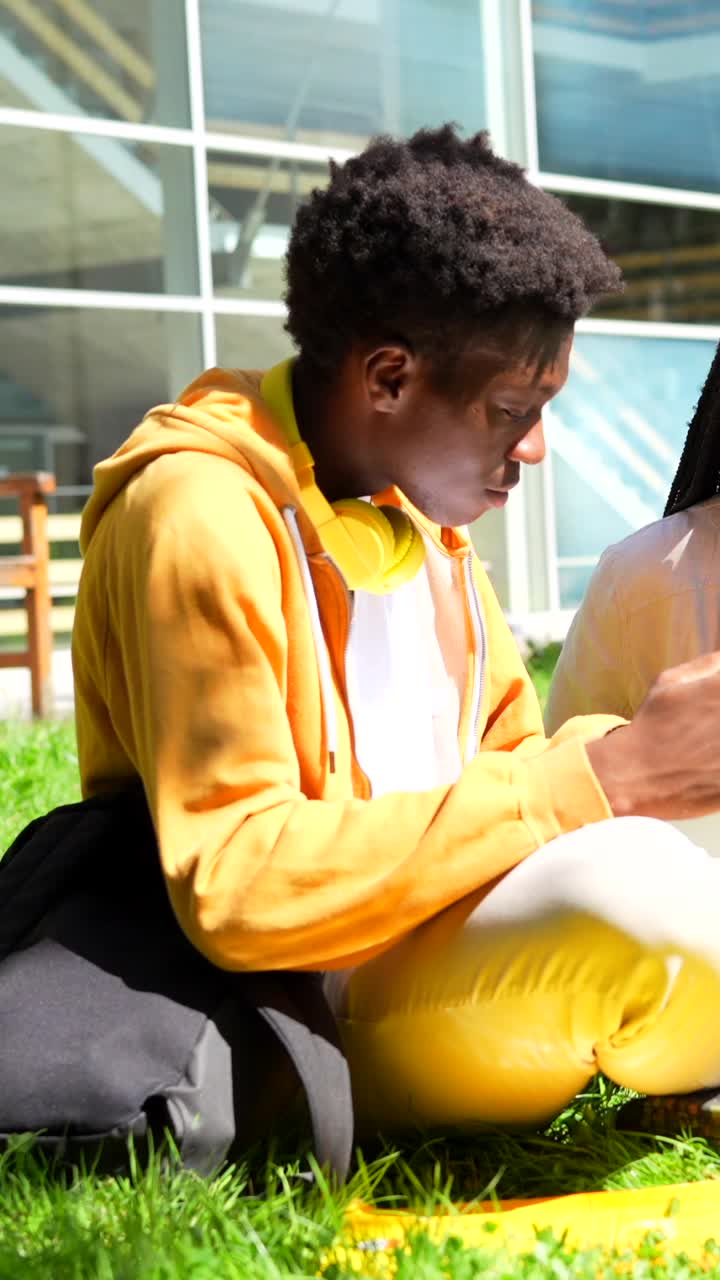 Students collaborating on a laptop outdoors