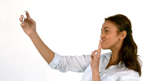 mujer casual tomando una selfie en fondo blanco