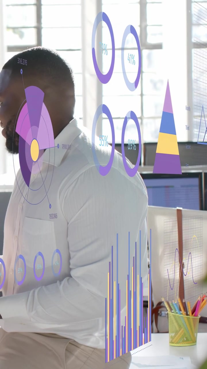 Vertical video: Rings and charts appearing, cycling over man at desk viewing device for business