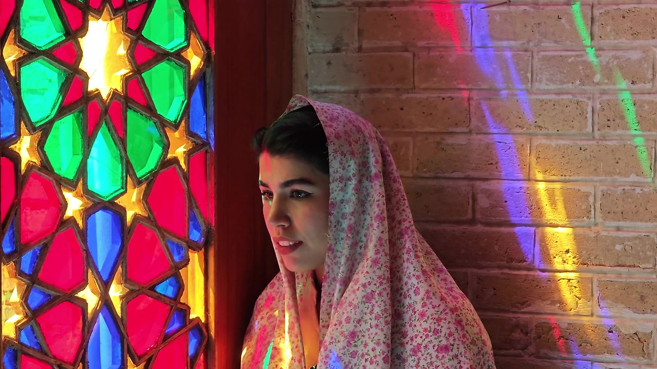 Young Woman Wearing Floral Headscarf Standing Beside Stained Glass Window