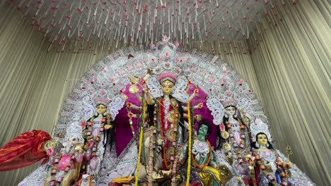 wide shot of daker saj durga maa idol at a puja pandal in kolkata.