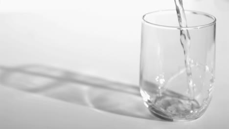 Trickle-of-water-in-a-super-slow-motion-flowing-into-a-glass-