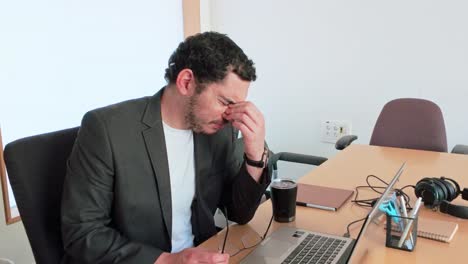exhausted young professional at computer