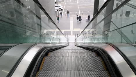 people ascending an escalator in melbourne