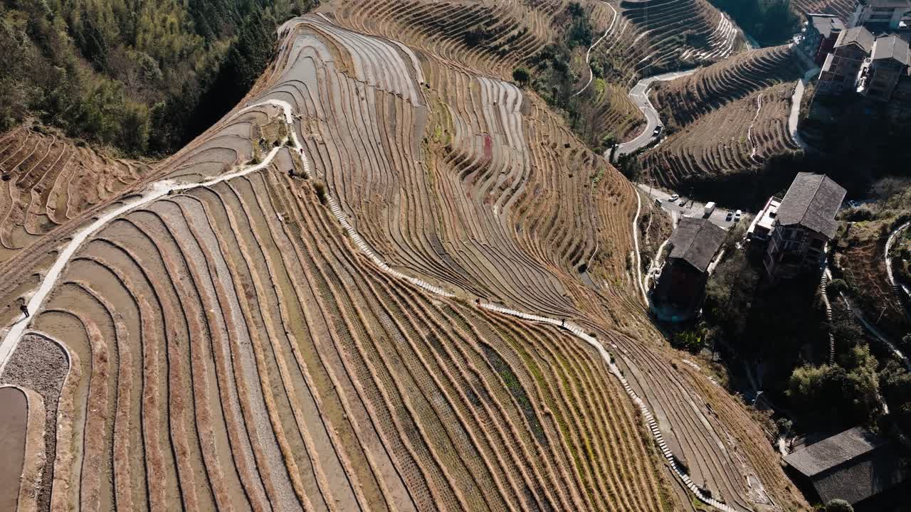 Drone view over patterned Longsheng rice terraces and hillside village near Guilin, China