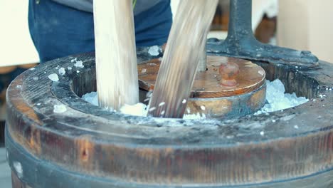 close up of pouring and breaking ice cubes in vintage ice cream machine