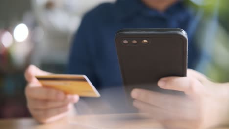 man typing credit card number to make an online purchase