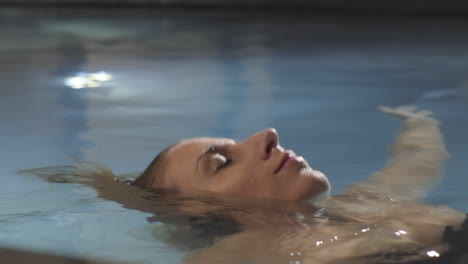 woman floating in pool