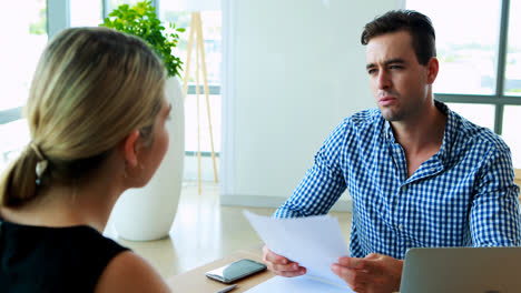 executives interacting with each other at desk