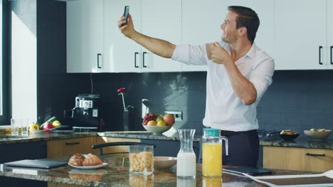 business man making selfie photo in kitchen. happy man taking photo in house.