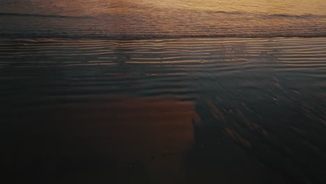 sea waves illuminated by the golden sunset in guanacaste, costa rica - drone shot