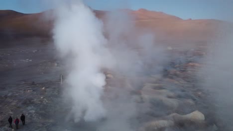 aerial camera flies through hot gas steam from geological geysers