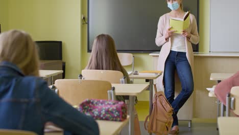 tracking video of teacher reading to school children in class.