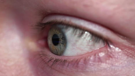 Macro-Shot-Of-An-Eye-Looking-At-The-Screen-Of-A-Smartphone,-Digital-Screen-Reflected-On-Eye