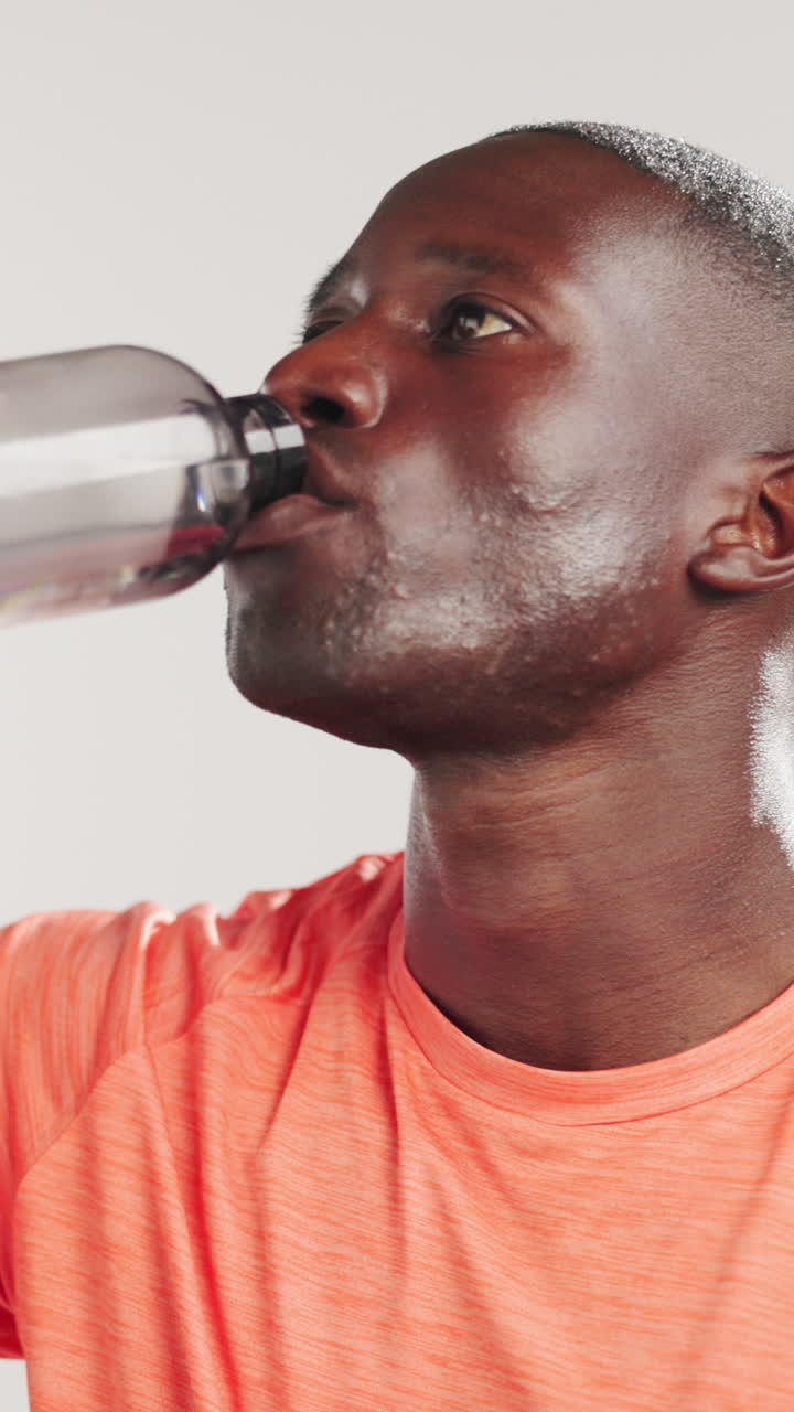 Close-up of Sweaty Young Black Man Drinking Water