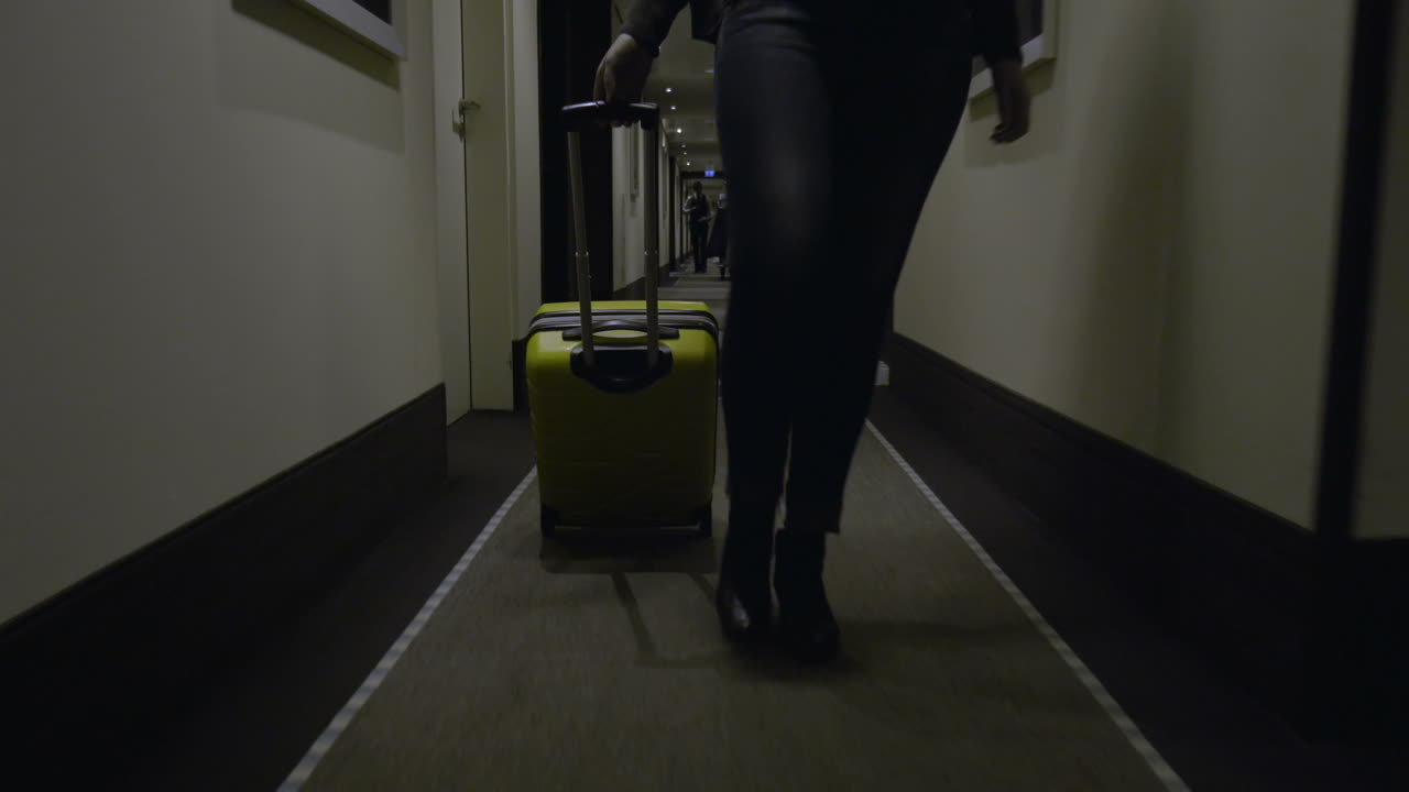 Woman tourist with suitcase arriving in the hotel