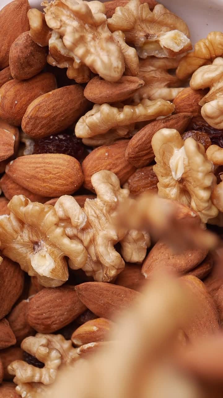 Almonds, Walnuts, and Raisins Falling into a Healthy Mix