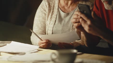 elderly couple calculating utility payments and joking