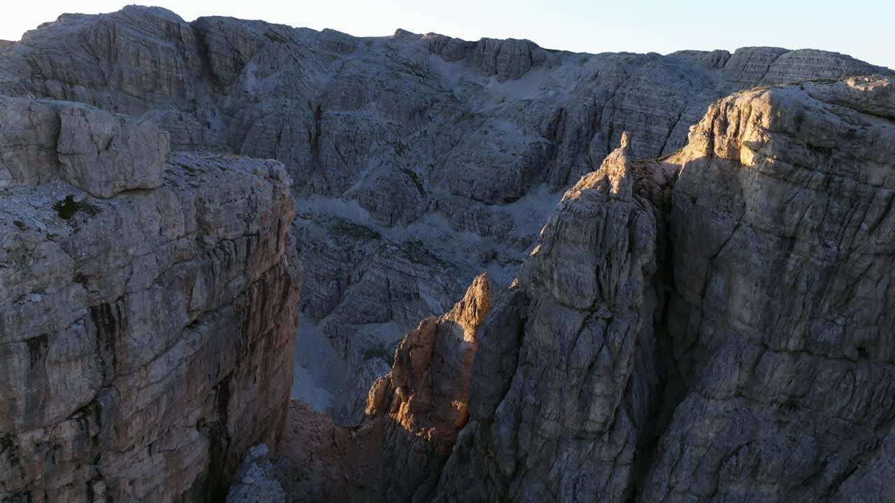Sweeping drone footage of the Dolomites' dramatic landscapes, showcasing the mountains' majesty in the gentle light of dawn