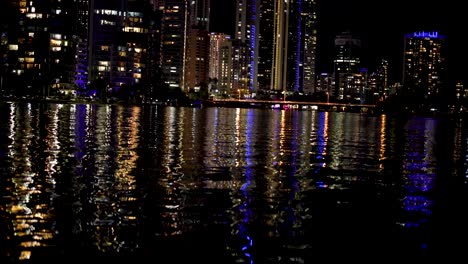 city lights reflecting on water at night