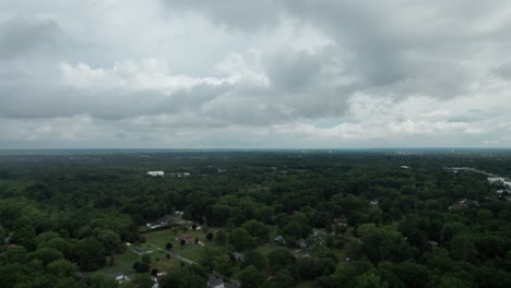 drone capture the town surrounded by the numerous trees with multiple building from the great height