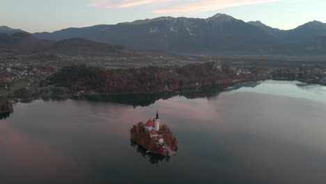 gorgeous morning sunrise of lake bled island with bright red skies with a aerial view of lake bled