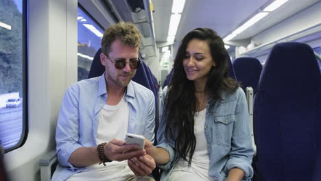 couple using a smartphone on a train