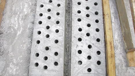 perforated concrete slab product with evenly spaced holes, part of construction process