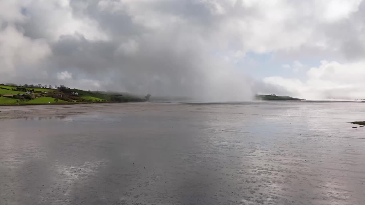 West Cork coastal region in Ireland with ocean mist lifting and creating clouds. Drone footage