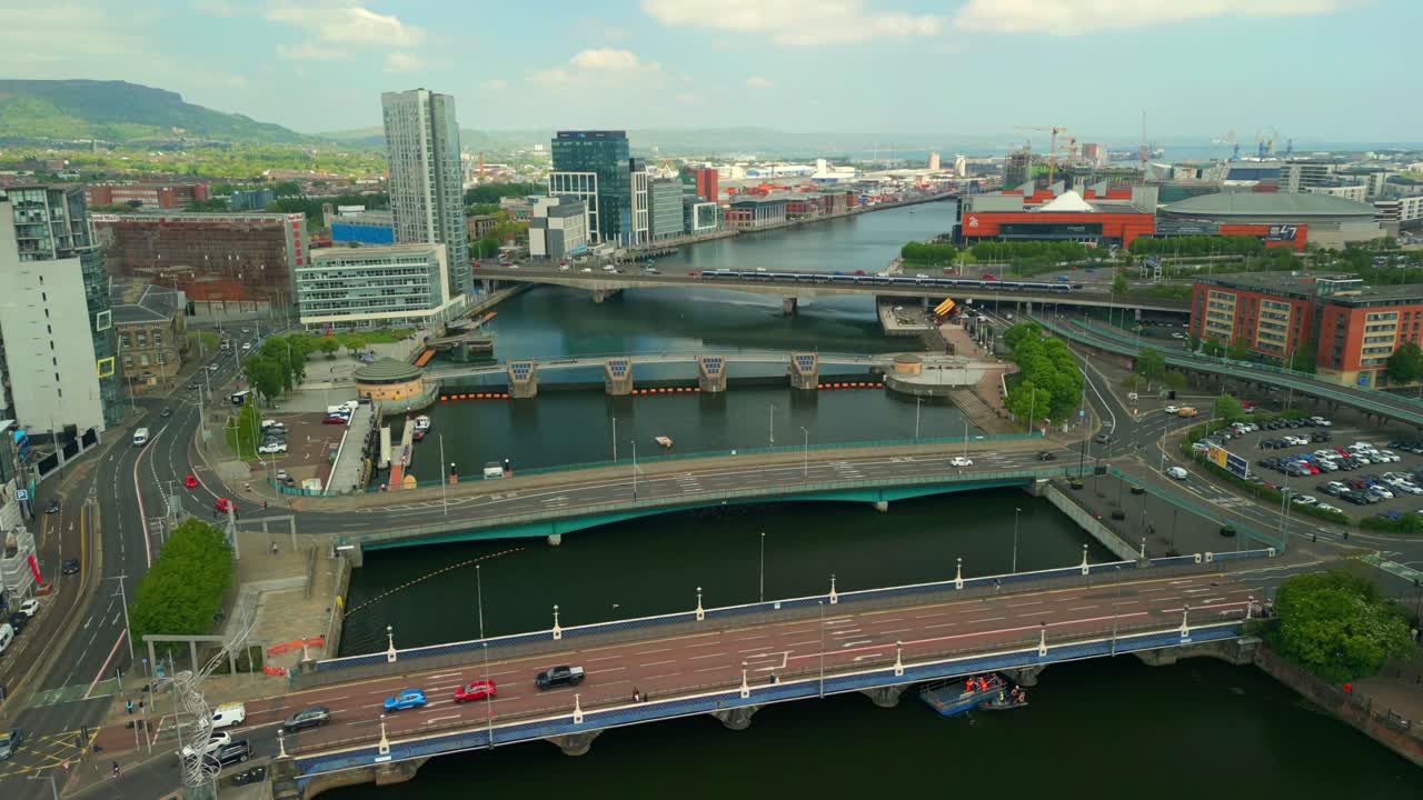 Overhead aerial video of Belfast City Centre and the River Lagan in Belfast, Northern Ireland in the UK on a bright sunny day. Filmed in 4K, 60FPS and in Rec709 Color.