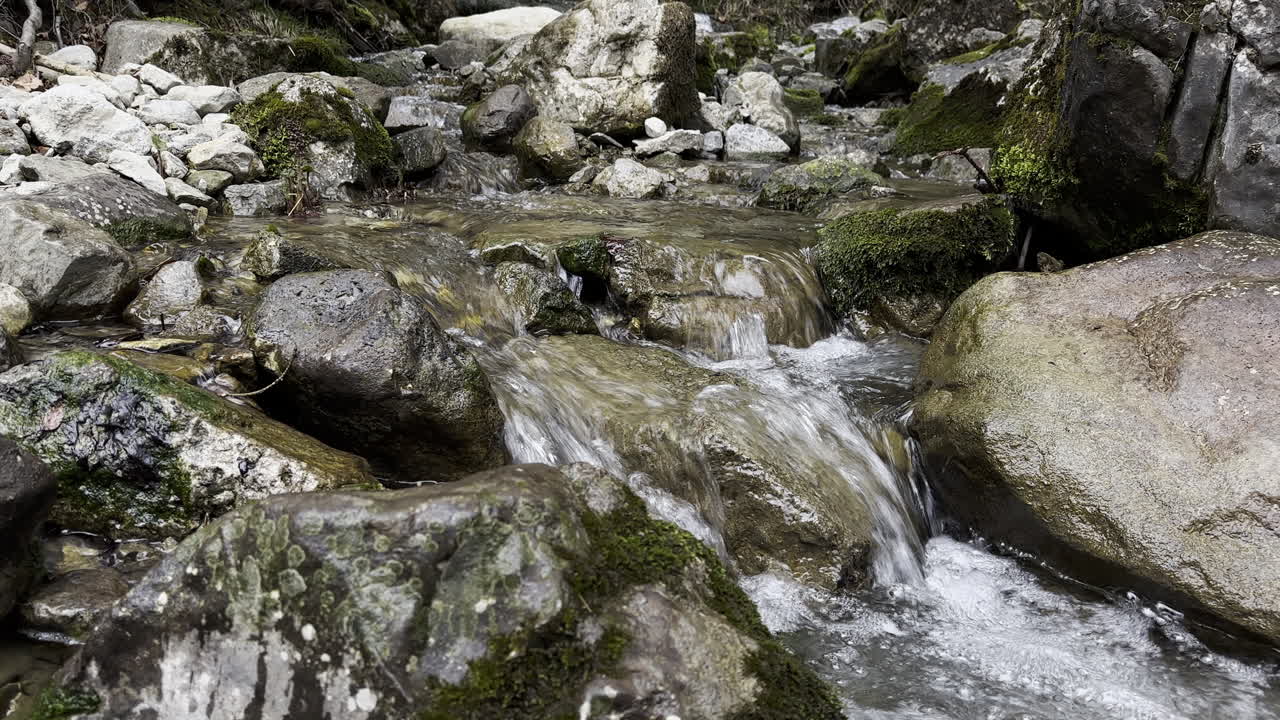 Close-up of stones with stream flowing