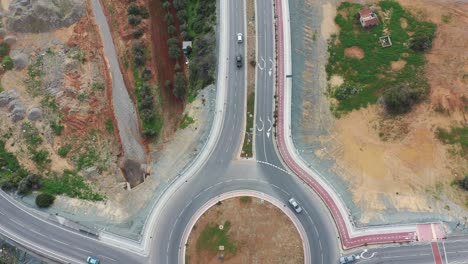 bird's eye view of urban traffic circles with highway overpass