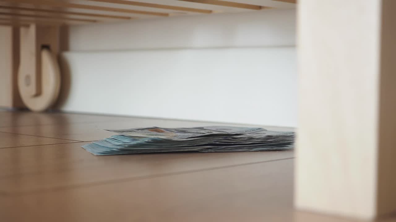Stack of Money Under Bed