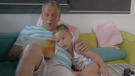 Grandfather-and-grandchild-with-laptop-at-home