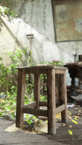 a rustic wooden stool in an abandoned room