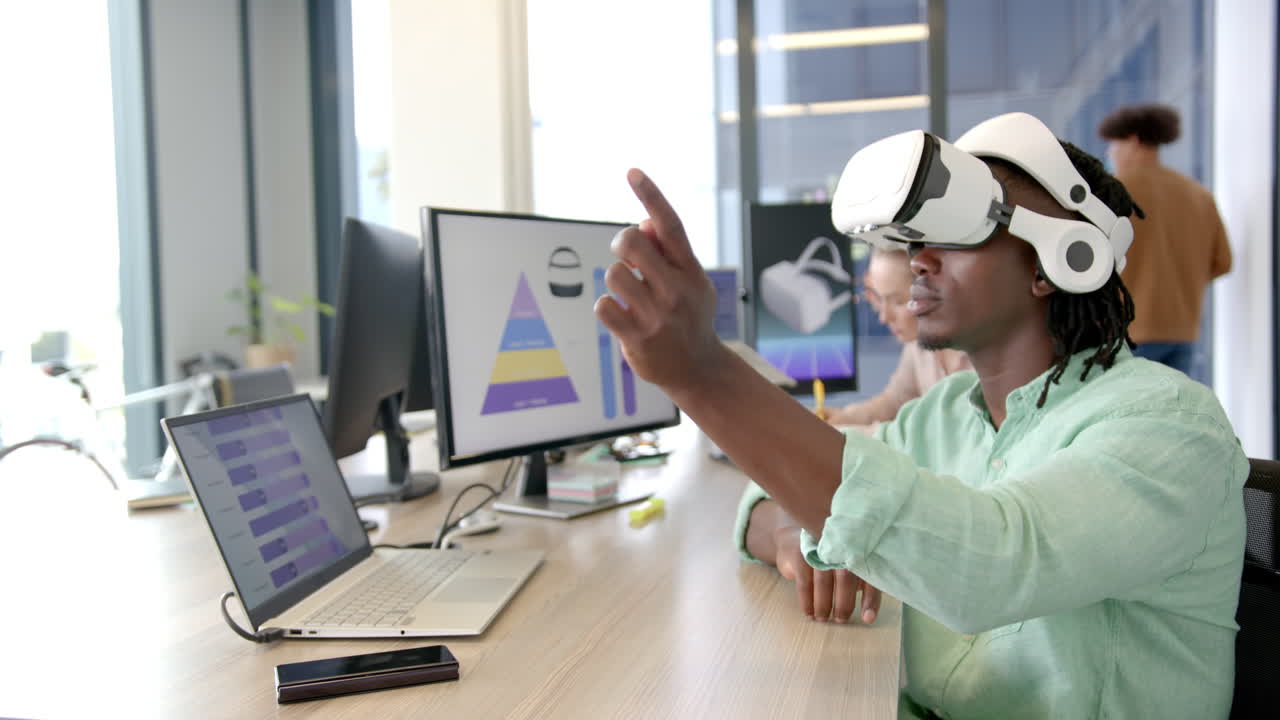 Using VR headset, man interacting with virtual interface in modern office
