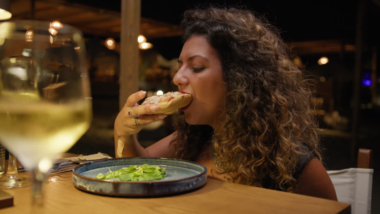 Woman Eating A Special Kind Of Fried Pizza For Dinner At The Restaurant