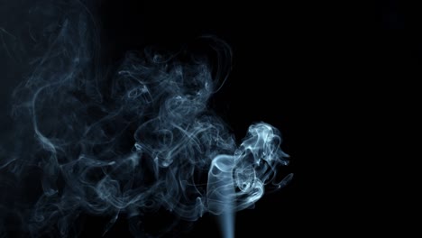 gray smoke on black background. smoke slowly dissipates filling the space.