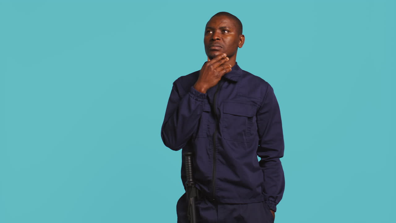 Portrait of pensive man in uniform rubbing chin