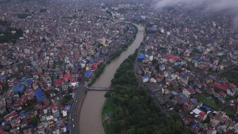 drone shot of bagmati river flooding in kathmandu, nepal, ruining citizen lives and causing widespread disaster