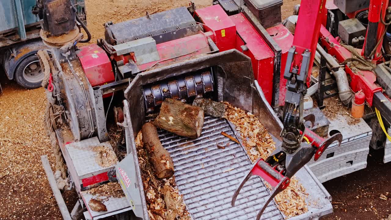 Wood chipper efficiently processes logs into fine wood chips, an industrial site