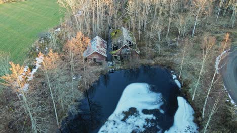 Drone slowly flying over an abandoned and collapsed sawmill in rural Sweden