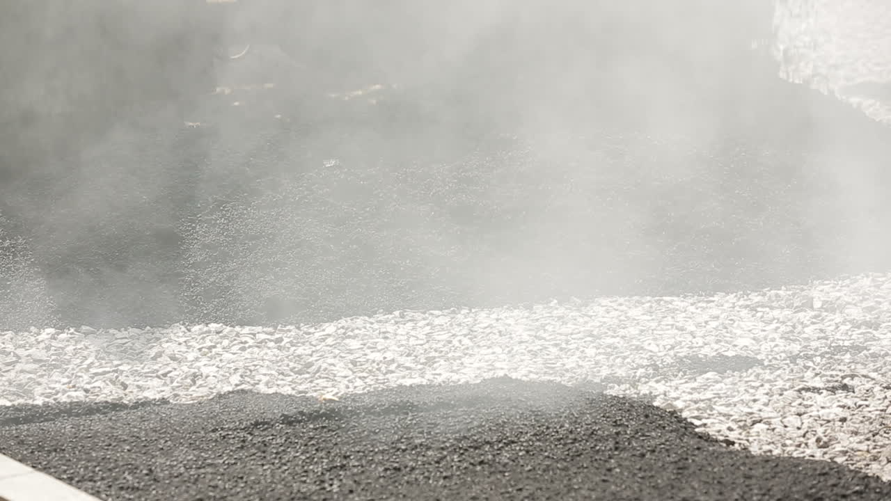 Truck Unloading Asphalt. Truck unloading asphalt at construction site during road works