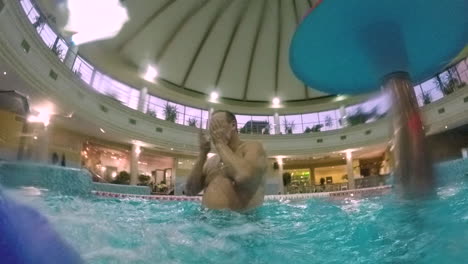 Grandpa-and-grandson-having-fun-in-indoor-water-park