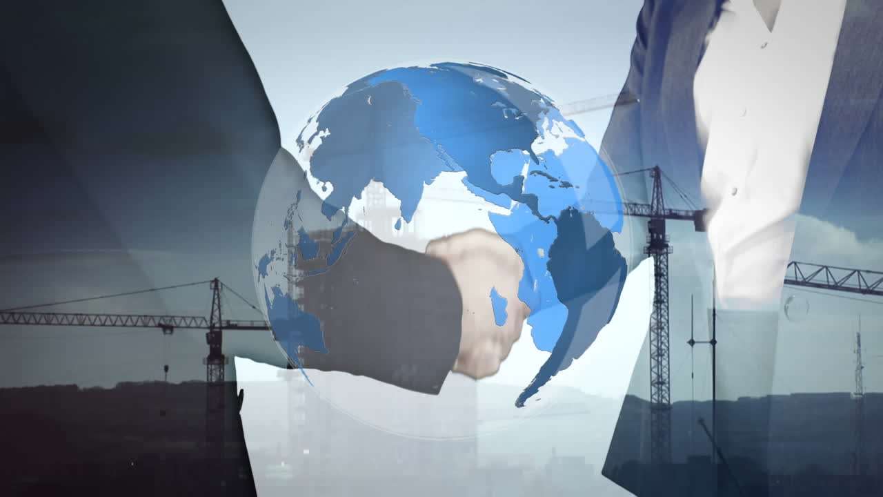 Businessmen shaking hands with rotating globe in foreground
